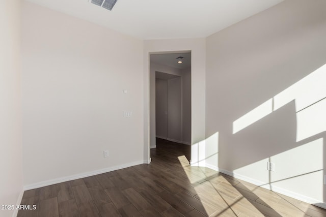 unfurnished room with wood-type flooring