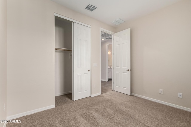 unfurnished bedroom with carpet and a closet