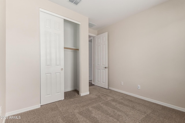 unfurnished bedroom featuring carpet and a closet