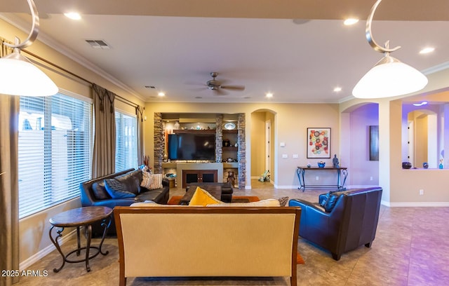 living room featuring ceiling fan, built in shelves, and ornamental molding