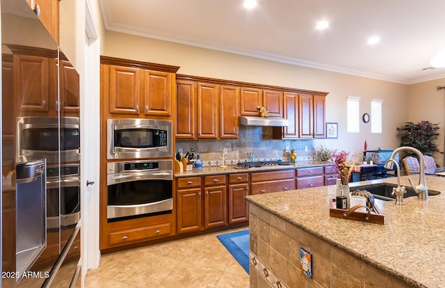 kitchen featuring sink, ornamental molding, tasteful backsplash, light stone countertops, and appliances with stainless steel finishes