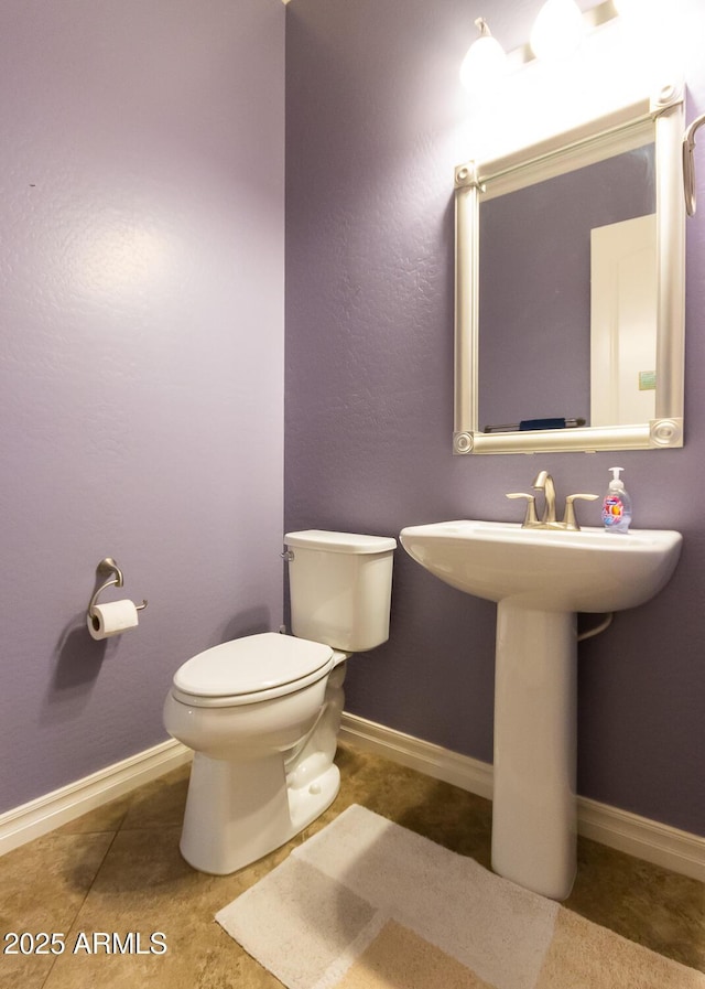 bathroom featuring sink, tile patterned flooring, and toilet