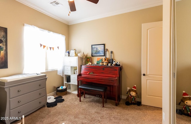 misc room with ornamental molding, ceiling fan, and light carpet