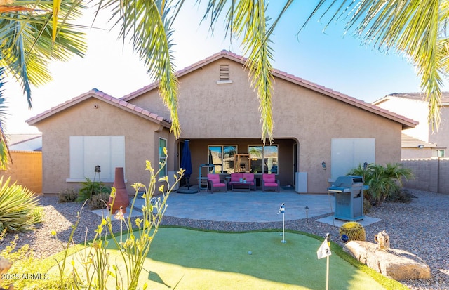 back of house featuring outdoor lounge area and a patio