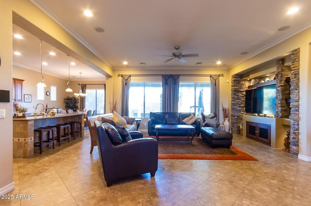 living room with light tile patterned flooring, ceiling fan, crown molding, and sink