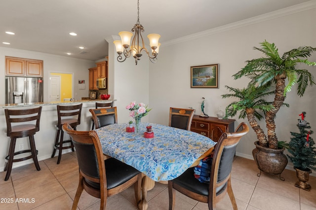 tiled dining area featuring a notable chandelier and ornamental molding