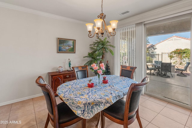 tiled dining room featuring ornamental molding and an inviting chandelier