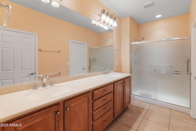 bathroom with tile patterned flooring, vanity, and a shower with door