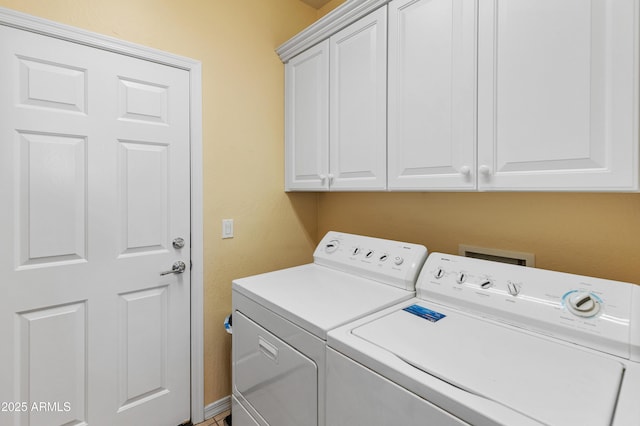 laundry room featuring cabinets and washing machine and clothes dryer