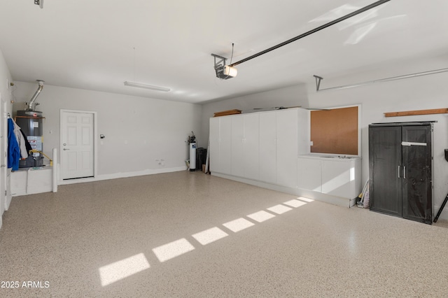 garage featuring a garage door opener and water heater