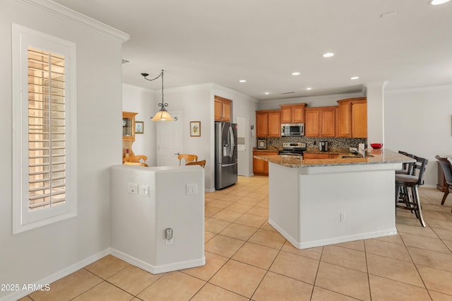 kitchen featuring light tile patterned flooring, appliances with stainless steel finishes, a breakfast bar area, kitchen peninsula, and light stone countertops