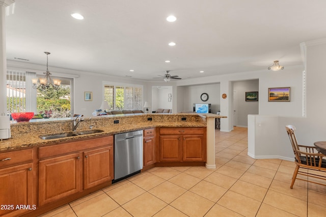 kitchen featuring decorative light fixtures, sink, light tile patterned floors, stainless steel dishwasher, and light stone counters