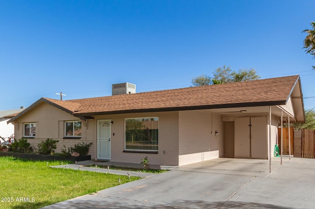 ranch-style home with a front yard and a carport