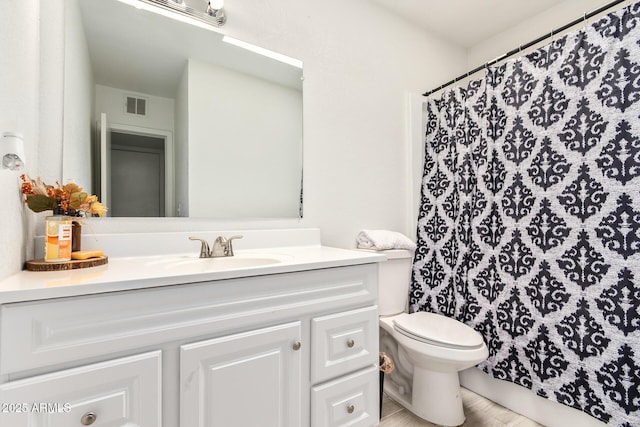 bathroom featuring vanity, toilet, and walk in shower