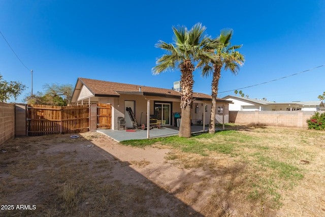 back of house featuring a patio and a lawn