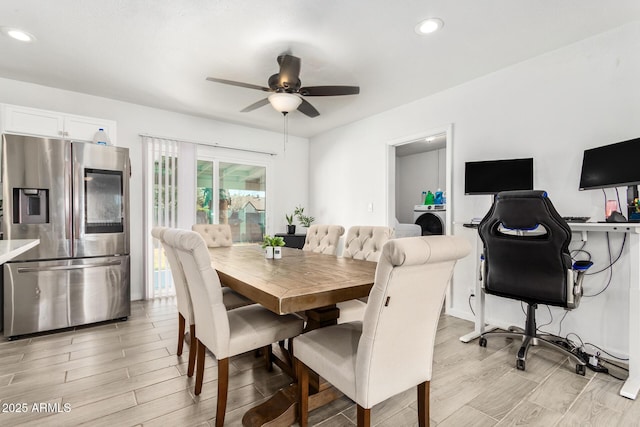 dining space featuring ceiling fan, washer / dryer, and light wood-type flooring