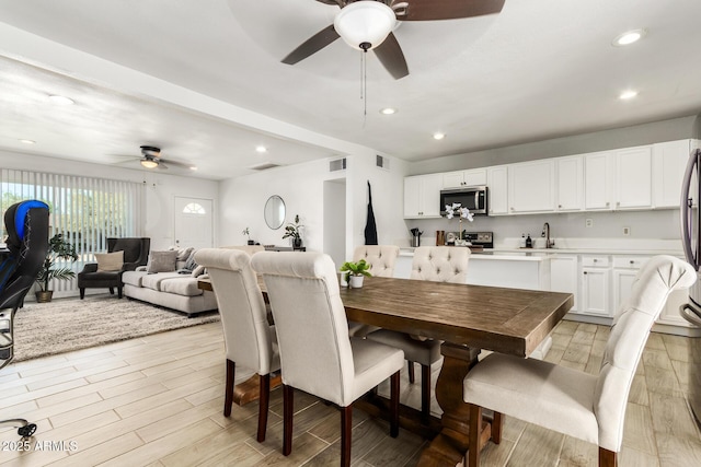 dining space with sink and ceiling fan