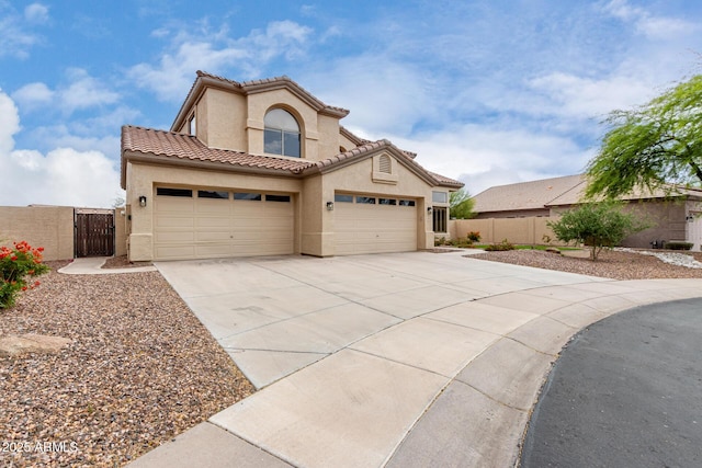 mediterranean / spanish-style house with a gate, fence, concrete driveway, a garage, and stucco siding