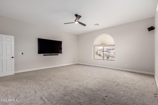 unfurnished living room with baseboards, visible vents, ceiling fan, and carpet