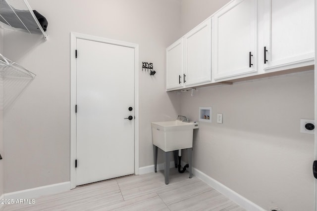 laundry room with cabinet space, washer hookup, baseboards, and electric dryer hookup