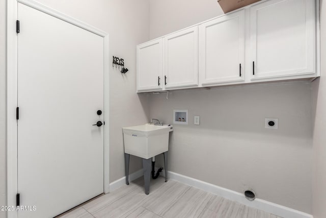 laundry room with hookup for an electric dryer, washer hookup, cabinet space, and baseboards