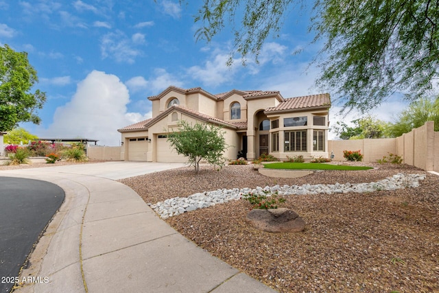 mediterranean / spanish-style house featuring fence, an attached garage, stucco siding, a tile roof, and concrete driveway