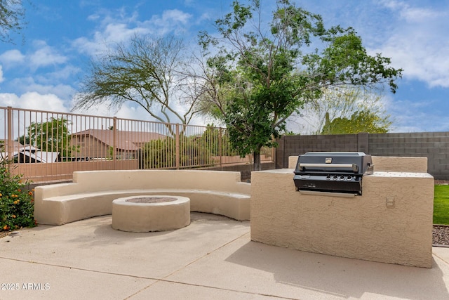 view of patio / terrace with area for grilling, a grill, and fence