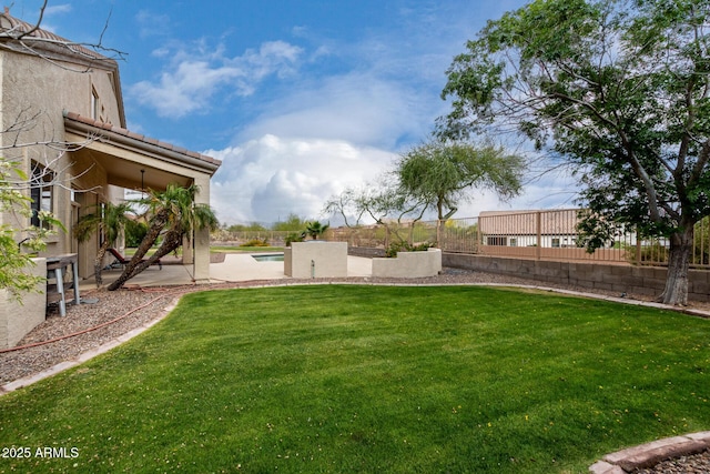 view of yard featuring a patio area, a fenced in pool, and a fenced backyard