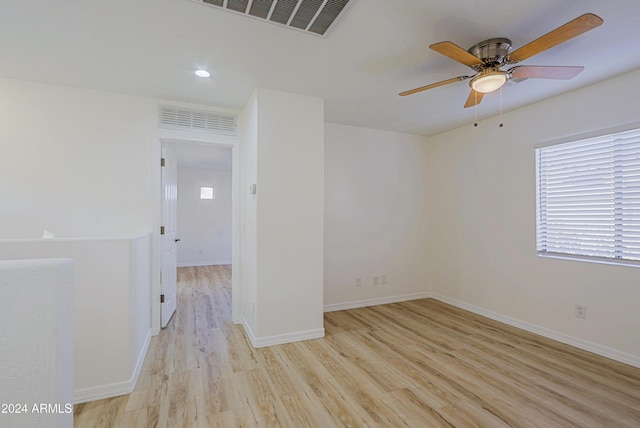 spare room featuring light hardwood / wood-style flooring and ceiling fan