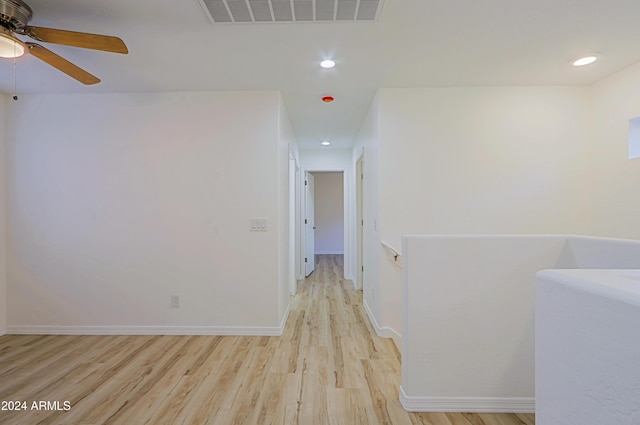 corridor with light hardwood / wood-style floors