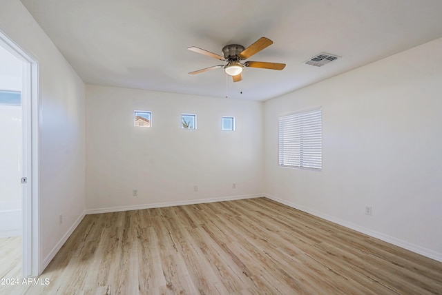 spare room with light hardwood / wood-style floors and ceiling fan