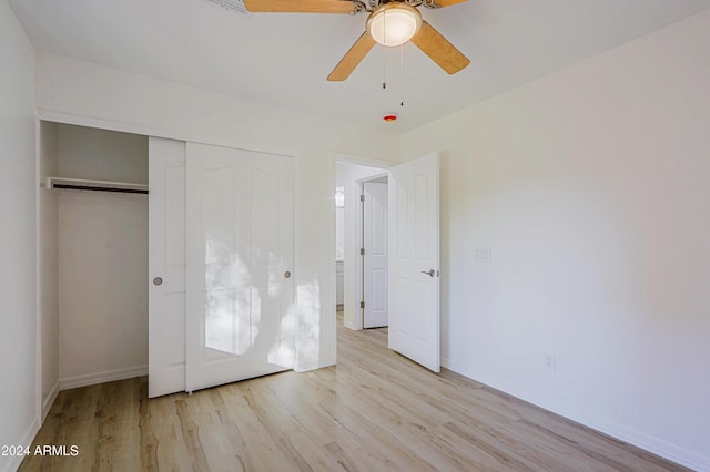 unfurnished bedroom with ceiling fan, a closet, and light hardwood / wood-style floors