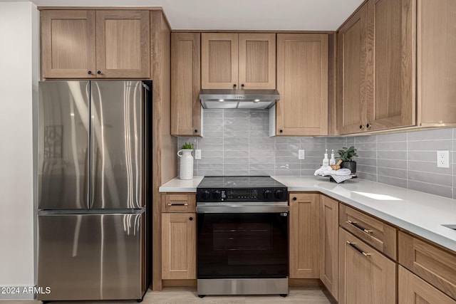 kitchen with decorative backsplash and appliances with stainless steel finishes