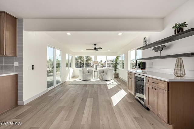 kitchen with wine cooler, ceiling fan, light hardwood / wood-style floors, and decorative backsplash