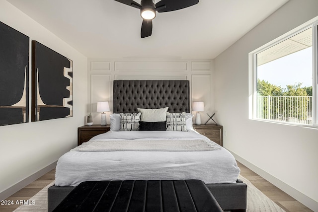 bedroom with light hardwood / wood-style floors and ceiling fan