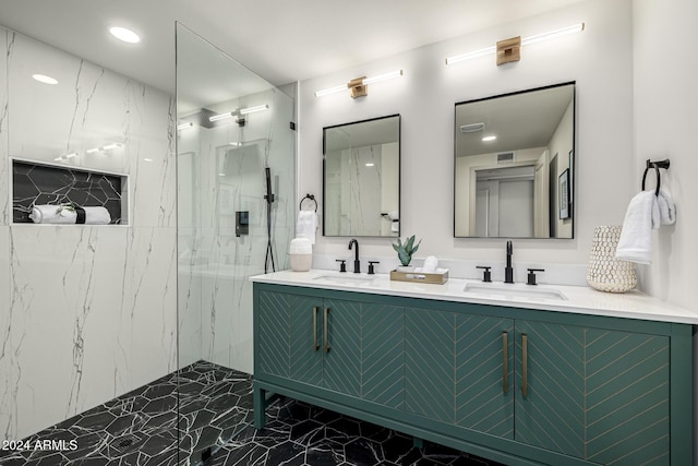 bathroom featuring a tile shower and vanity