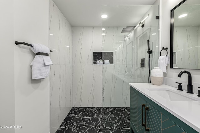 bathroom featuring a tile shower and vanity