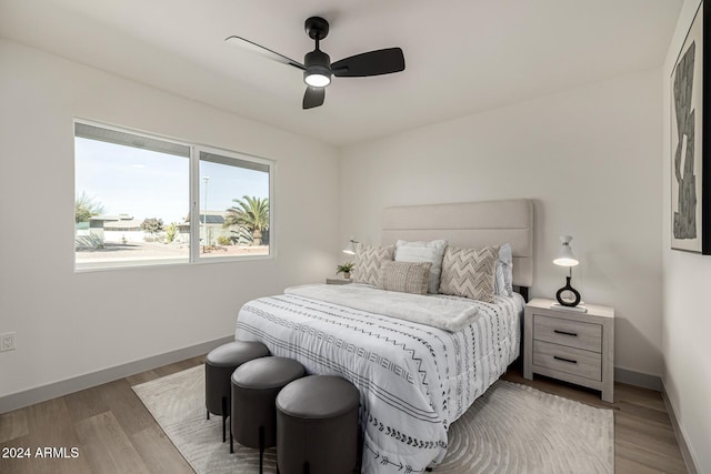 bedroom with ceiling fan and light hardwood / wood-style floors