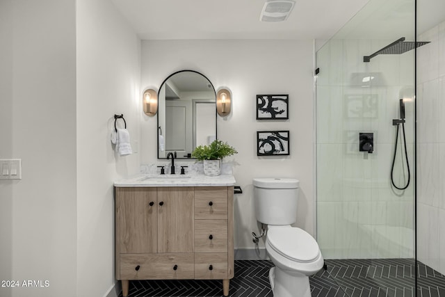 bathroom with tile patterned flooring, vanity, toilet, and a shower with shower door