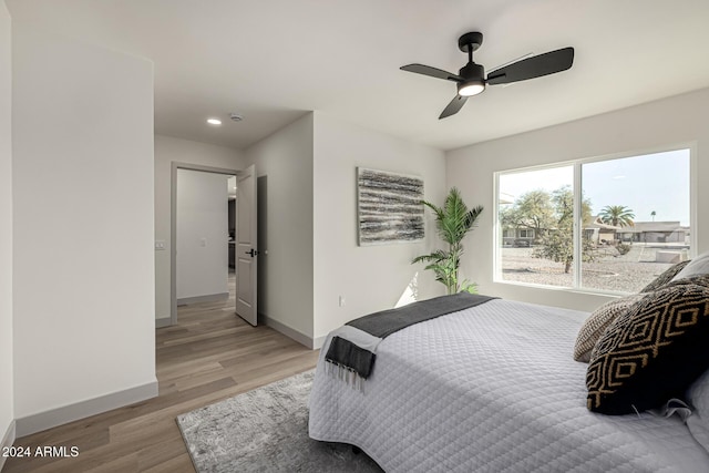 bedroom with ceiling fan and light hardwood / wood-style floors