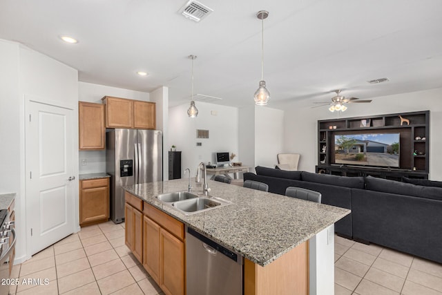 kitchen featuring a sink, appliances with stainless steel finishes, light tile patterned floors, and visible vents