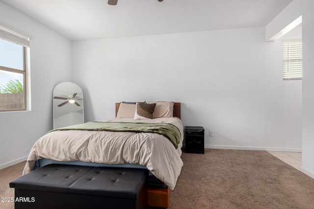 carpeted bedroom featuring baseboards and ceiling fan