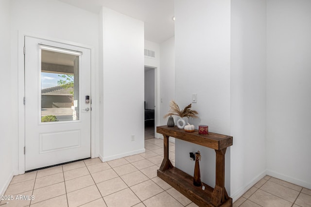 entryway featuring baseboards, visible vents, and light tile patterned floors