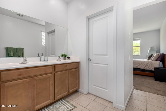 full bath featuring double vanity, visible vents, a sink, tile patterned floors, and ensuite bathroom