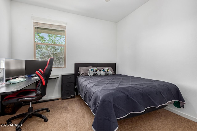 bedroom with baseboards and carpet
