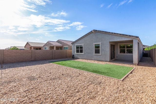 back of house with a patio, a fenced backyard, and stucco siding