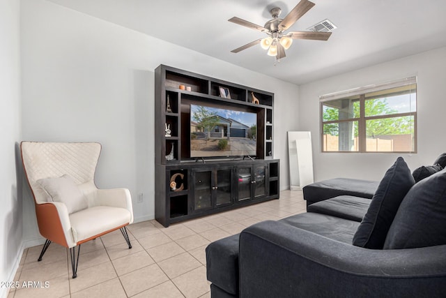 tiled living area featuring baseboards, ceiling fan, and visible vents