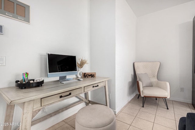 home office featuring baseboards and light tile patterned floors