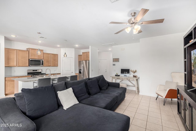 living area featuring recessed lighting, ceiling fan, and light tile patterned flooring