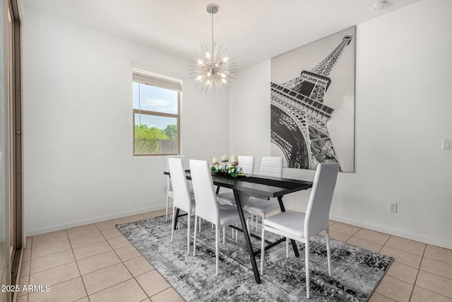 dining area with baseboards, an inviting chandelier, and tile patterned flooring